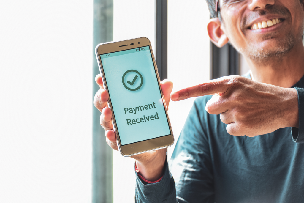 Hands receiving a cash payment for a house sale